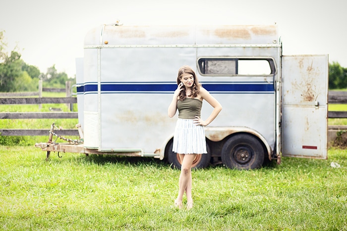 High School Senior Girl at Blackacre Farm standing next to Rustic Fence