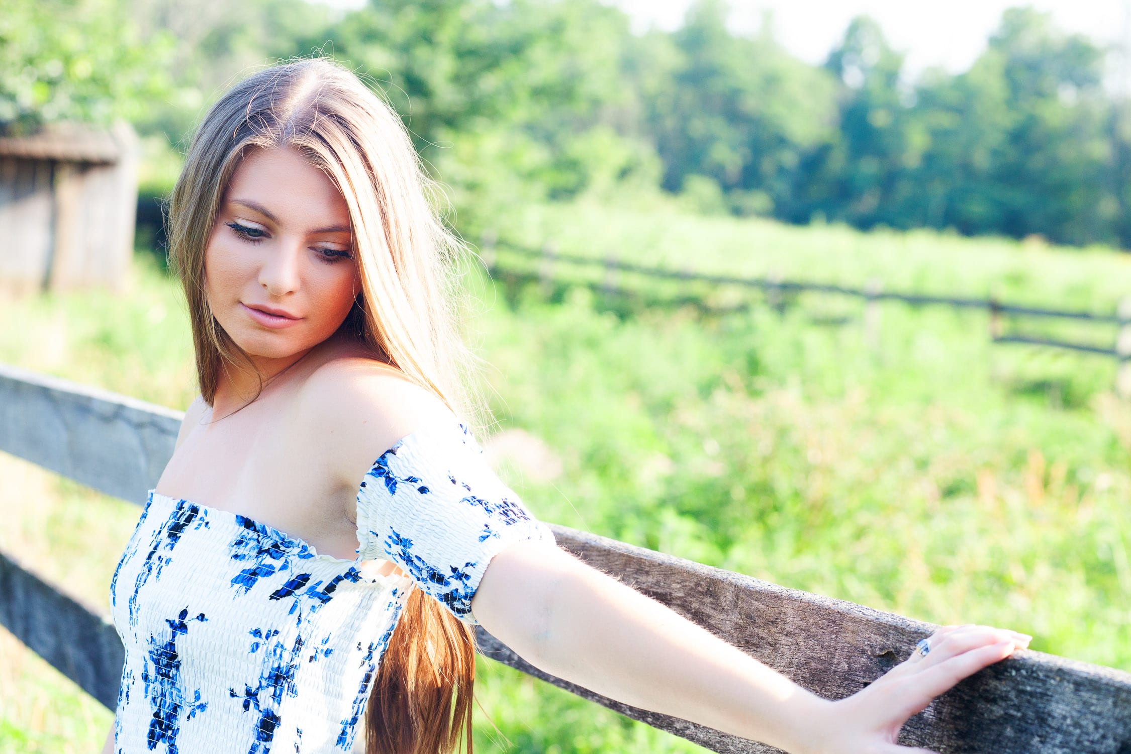 louisville senior girl at blackacre farm leaning against wooden fence