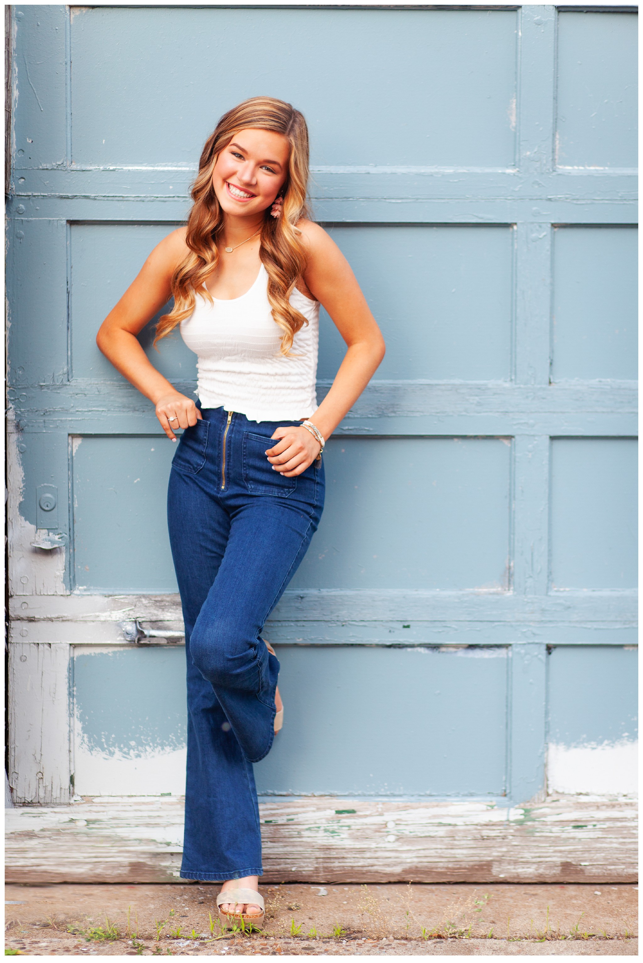 Louisville Senior Picture of gir leaning against blue garage.