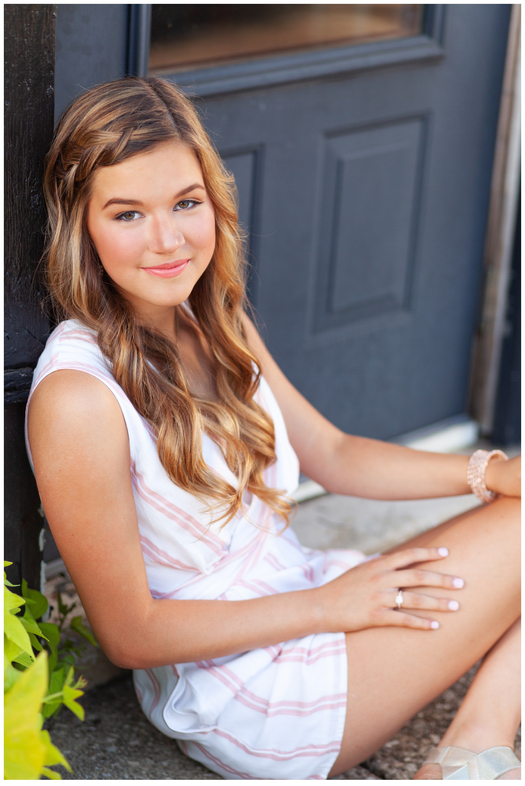 Louisville Senior Picture leaning against blue door.