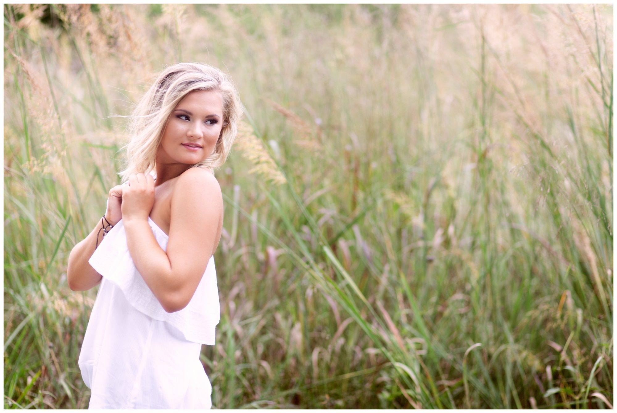 High School Senior Girl in Off Shoulder White Shirt in Field