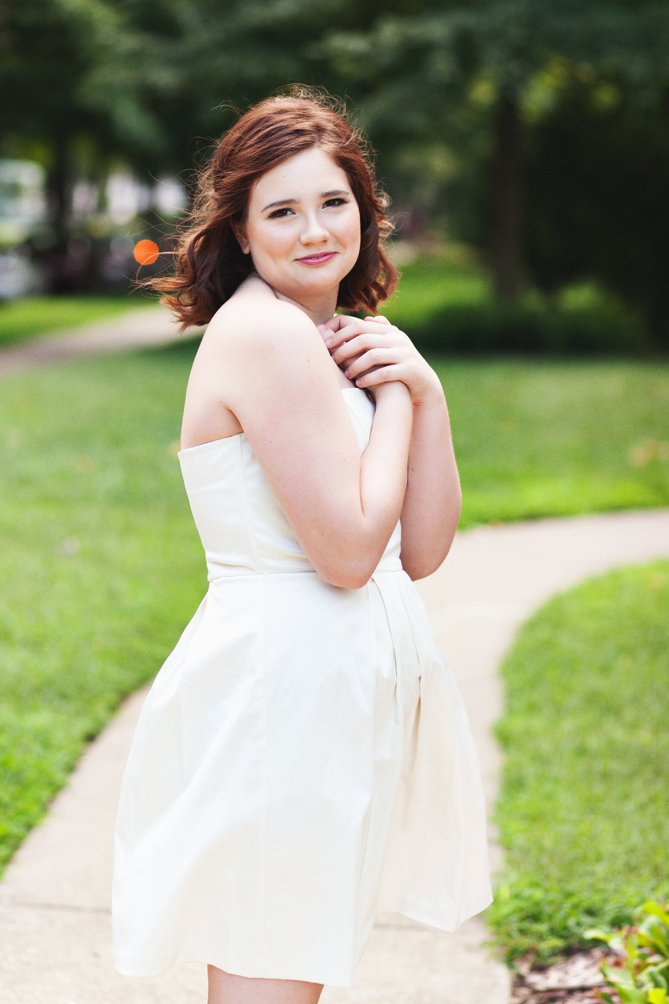 Senior Girl standing in white dress in Saint James Court